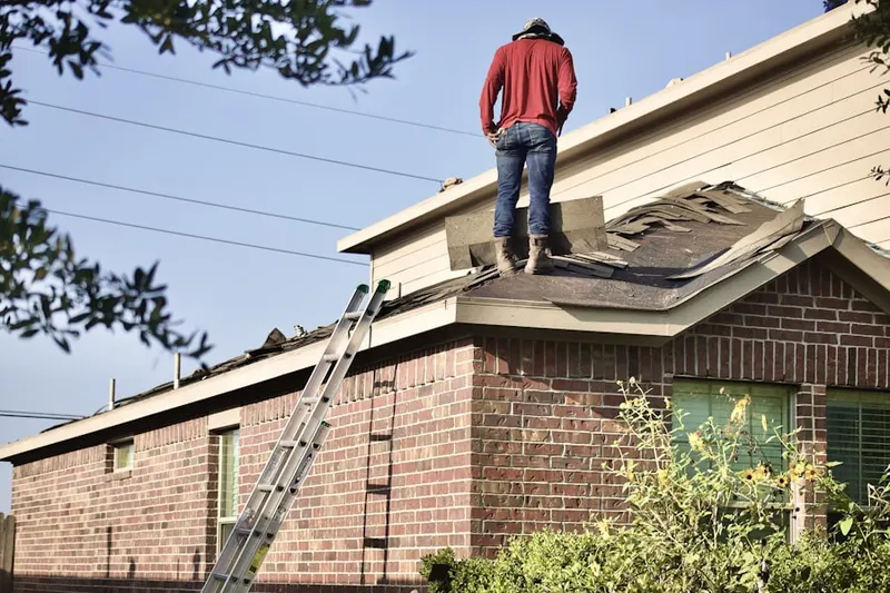Professional roofer working on a residential roof in Wrights Crossroads